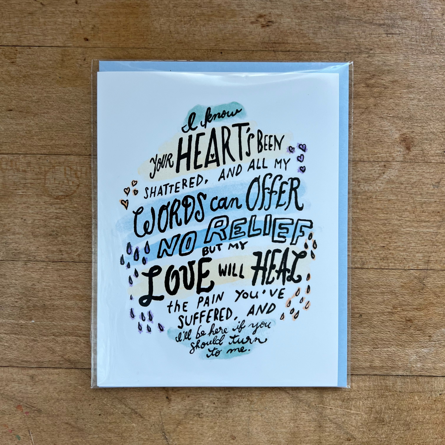 Greeting card with poetic text on a wooden surface